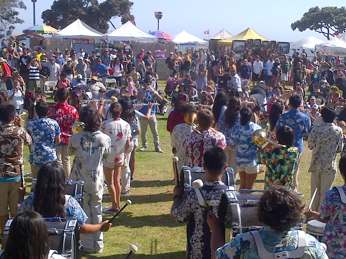A crowd enjoying the festival on the lawn at Promenade Park