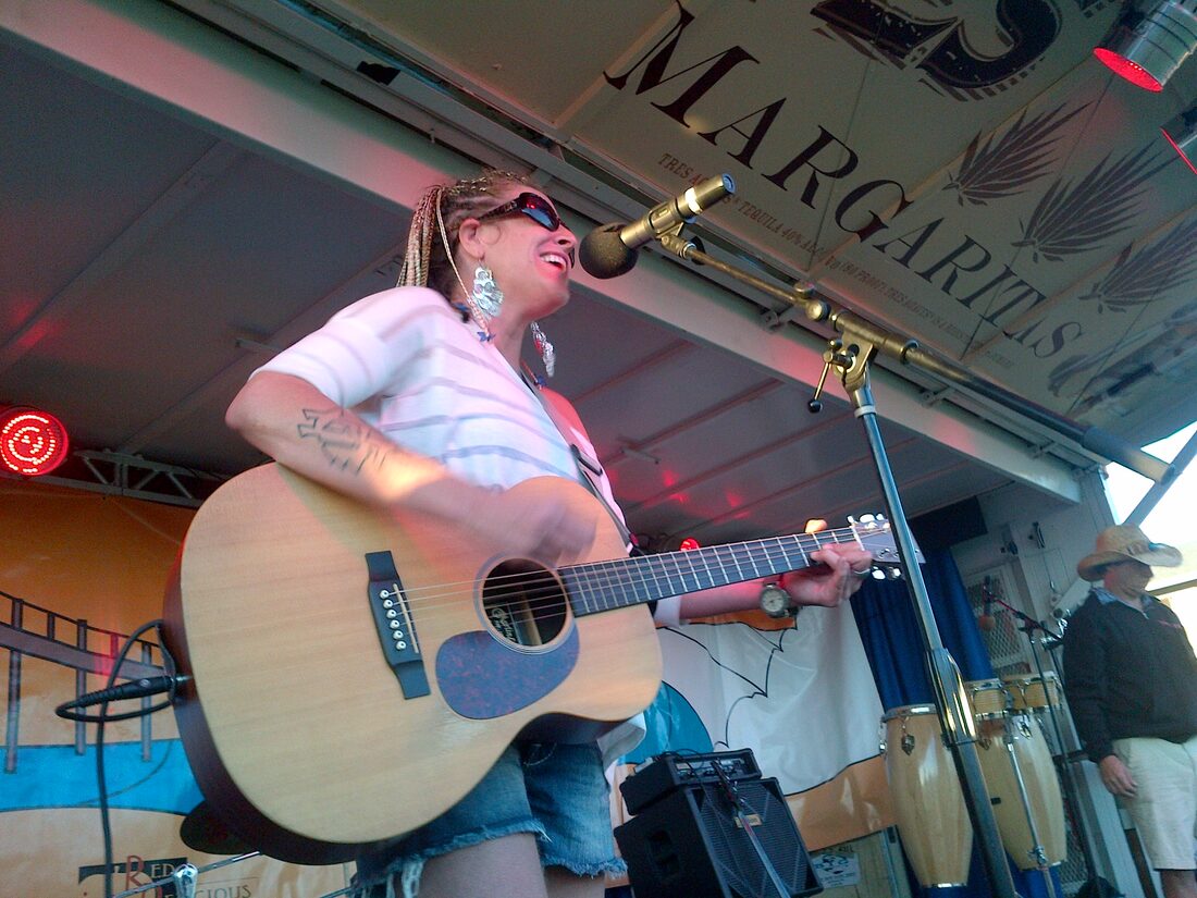Solo guitarist singing on stage at the festival