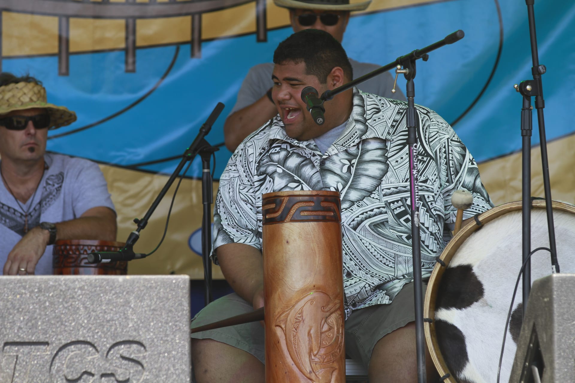Polynesian drummer playing traditional drums on stage