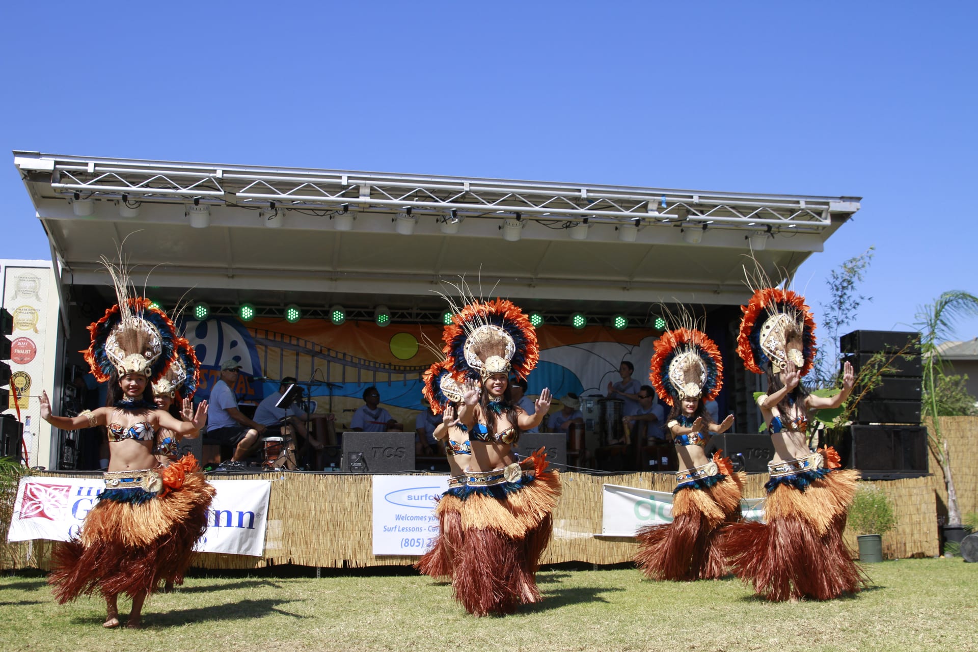 Polynesian dancers with feather headdresses on the Main Stage