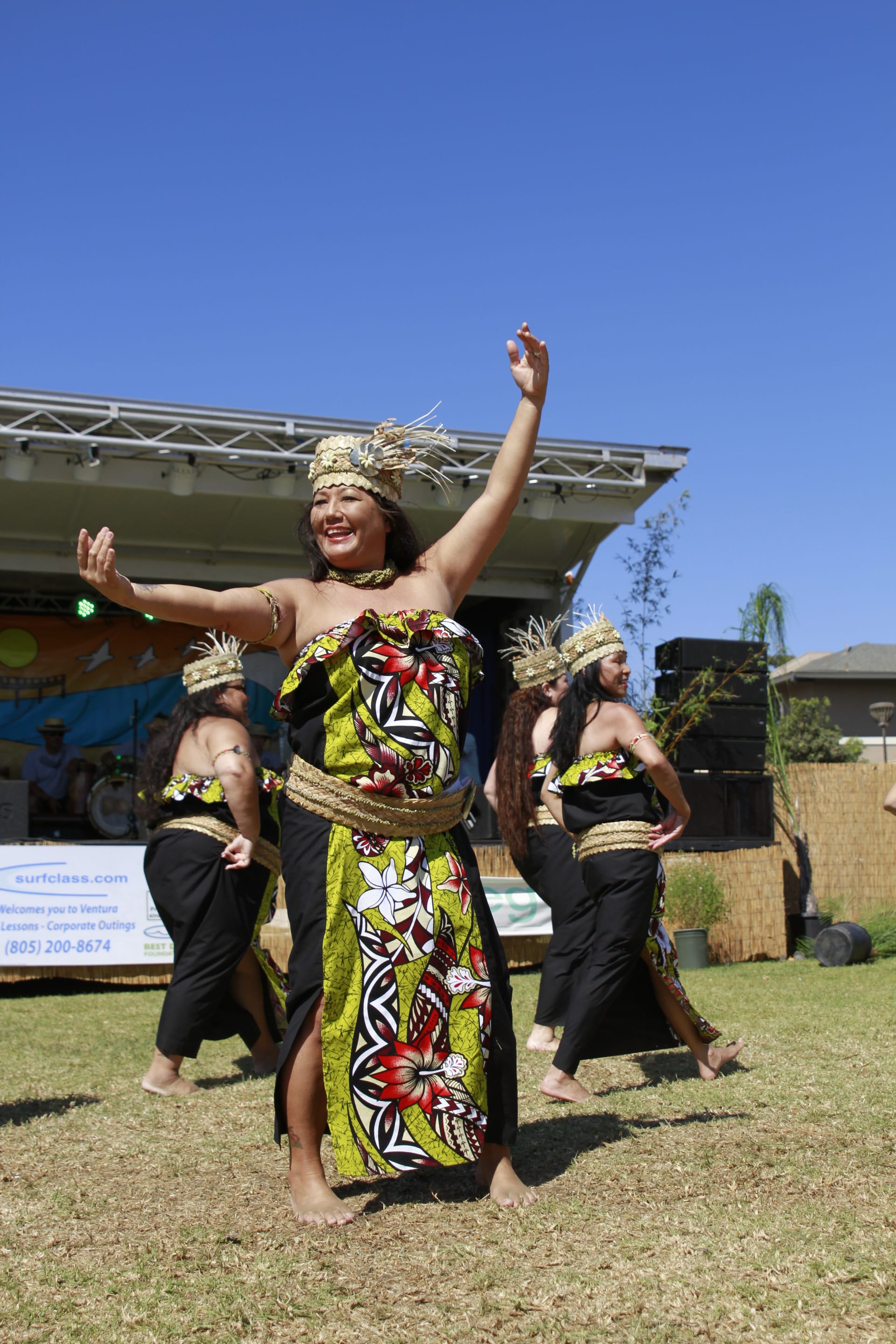 Solo female dancer in floral dress mid-performance