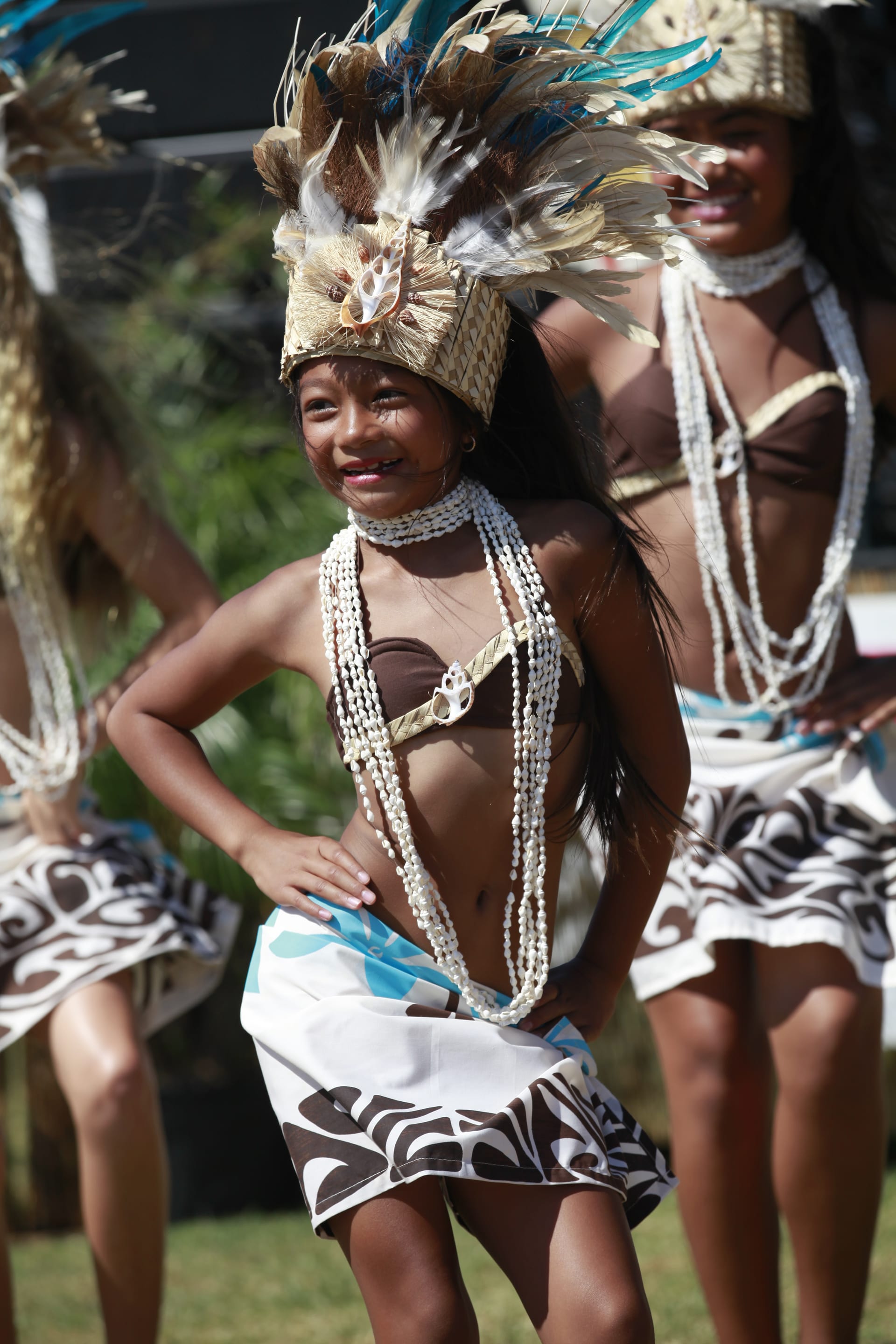 Dancers close-up in shell and feather regalia